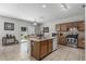 Well-equipped kitchen with island, stainless steel appliances and bright natural lighting at 14318 N 142Nd Ln, Surprise, AZ 85379