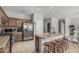 Open kitchen with island seating, stainless steel appliances, and easy access to other living areas at 14318 N 142Nd Ln, Surprise, AZ 85379