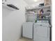 Functional laundry room with modern appliances and ample shelving for organized storage at 14318 N 142Nd Ln, Surprise, AZ 85379