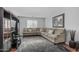 Spacious living room with sectional sofa, textured rug, large TV stand, and modern decor at 14318 N 142Nd Ln, Surprise, AZ 85379