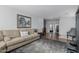 Bright living room with a large sofa, wood floors, a stylish rug, and modern artwork at 14318 N 142Nd Ln, Surprise, AZ 85379