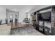 Spacious living room featuring hardwood floors and a modern entertainment center at 14318 N 142Nd Ln, Surprise, AZ 85379