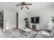 Bright living room with neutral colors, a ceiling fan, and a cozy seating area at 14318 N 142Nd Ln, Surprise, AZ 85379