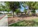 Charming community picnic area with covered pavilion, barbecue grills, and mature shade trees at 14318 N 142Nd Ln, Surprise, AZ 85379