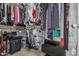 Organized walk-in closet featuring hanging clothes, shelving, and storage containers maximizing space at 14318 N 142Nd Ln, Surprise, AZ 85379