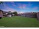 Spacious backyard with lush lawn and covered patio providing an ideal space for entertaining and recreation at 15245 W Crocus Dr, Surprise, AZ 85379