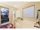 Bright bathroom featuring a standalone shower, soaking tub, and access to a walk-in closet at 15245 W Crocus Dr, Surprise, AZ 85379