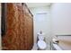 Bathroom featuring toilet, curtain, and neutral colored walls at 15245 W Crocus Dr, Surprise, AZ 85379