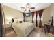 Bedroom with carpet, ceiling fan, and flat screen television on wall at 15245 W Crocus Dr, Surprise, AZ 85379