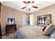 Bedroom featuring carpet, ceiling fan, and vanity with mirror at 15245 W Crocus Dr, Surprise, AZ 85379