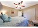 Bedroom with wood flooring, a ceiling fan, and large closet at 15245 W Crocus Dr, Surprise, AZ 85379