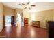 Large bedroom featuring tiled floors, ceiling fan, and a door to another room at 15245 W Crocus Dr, Surprise, AZ 85379