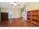 Spacious bedroom featuring wood-look flooring, ceiling fan, and access to a walk-in closet at 15245 W Crocus Dr, Surprise, AZ 85379