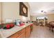 Well-lit kitchen with granite counters open to a living area that creates a warm and inviting space at 15245 W Crocus Dr, Surprise, AZ 85379
