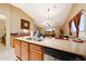 Kitchen boasts granite counters, stainless appliances, and an open layout connected to the dining and living areas at 15245 W Crocus Dr, Surprise, AZ 85379