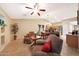 Open-concept living area features tile floors, ceiling fan, and easy access to the kitchen and dining space at 15245 W Crocus Dr, Surprise, AZ 85379