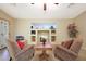 Bright living room features built-in shelving, cozy armchairs, and neutral color scheme at 15245 W Crocus Dr, Surprise, AZ 85379