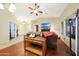 Bright living room with ample space, complemented by a stylish ceiling fan and large windows at 15245 W Crocus Dr, Surprise, AZ 85379
