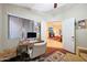 Office with natural light leads to a living space with a fireplace, creating an inviting atmosphere at 15245 W Crocus Dr, Surprise, AZ 85379