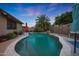 Private backyard pool with mature palm tree, providing a tranquil oasis for relaxation and enjoyment at 15245 W Crocus Dr, Surprise, AZ 85379