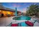 Backyard pool and patio featuring lounge chairs and lush landscaping, perfect for enjoying the Arizona sunshine at 15245 W Crocus Dr, Surprise, AZ 85379