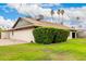 Well-manicured backyard showcasing lush greenery, gravel landscaping, and mature palm trees at 15424 N 52Nd Pl, Scottsdale, AZ 85254