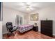 Bedroom features a comfortable bed, a ceiling fan, and laminate floors at 15424 N 52Nd Pl, Scottsdale, AZ 85254