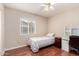 Bedroom features a ceiling fan, laminate flooring, and a desk near the window at 15424 N 52Nd Pl, Scottsdale, AZ 85254