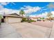 Charming single-story home featuring well-kept landscaping, a two-car garage and long driveway at 15424 N 52Nd Pl, Scottsdale, AZ 85254