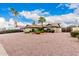 Well maintained single story home with desert landscaping, with palm trees and rock groundcover in the front yard at 15424 N 52Nd Pl, Scottsdale, AZ 85254
