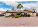 Beautiful home with desert landscaping, mature trees, and a charming brick facade at 15424 N 52Nd Pl, Scottsdale, AZ 85254