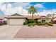 Charming single-story home featuring well-kept landscaping, a two-car garage, and a beautiful palm tree at 15424 N 52Nd Pl, Scottsdale, AZ 85254