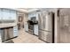 Bright kitchen features stainless steel appliances, including refrigerator, range, and dishwasher at 15424 N 52Nd Pl, Scottsdale, AZ 85254