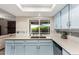 Well-lit kitchen with stainless appliances, blue cabinets and natural light at 15424 N 52Nd Pl, Scottsdale, AZ 85254