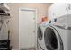 Bright laundry room featuring a modern washer and dryer and ample storage space at 15424 N 52Nd Pl, Scottsdale, AZ 85254