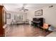 Spacious living room featuring hardwood floors, a ceiling fan and a grand piano at 15424 N 52Nd Pl, Scottsdale, AZ 85254