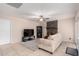 Open-concept living room with stone fireplace, TV, and access to other rooms at 15424 N 52Nd Pl, Scottsdale, AZ 85254