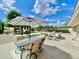 Outdoor entertaining area with a pool, a patio table, and lush landscaping at 15602 N 37Th St, Phoenix, AZ 85032