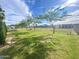 Backyard featuring grassy lawn, mature trees, and fencing at 15602 N 37Th St, Phoenix, AZ 85032
