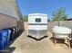 Backyard view featuring a white horse trailer and storage tanks, perfect for rural living at 15602 N 37Th St, Phoenix, AZ 85032