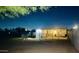 Exterior view of the barn at night with a horse standing in front at 15602 N 37Th St, Phoenix, AZ 85032