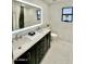 Elegant bathroom with marble accents, dual sinks, modern lighting, and sleek dark vanity at 15602 N 37Th St, Phoenix, AZ 85032
