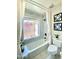 Bright bathroom with a tub and shower combo, featuring a window with a view and tile surround at 15602 N 37Th St, Phoenix, AZ 85032