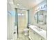 Bright bathroom with updated vanity, shower with blue curtain, toilet, stacked washer/dryer, and modern fixtures at 15602 N 37Th St, Phoenix, AZ 85032