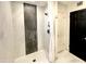 Contemporary shower with marble-style tiling, dual showerheads, and sleek fixtures at 15602 N 37Th St, Phoenix, AZ 85032