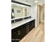 Modern bathroom featuring a double vanity with a marble countertop and lighted mirror at 15602 N 37Th St, Phoenix, AZ 85032