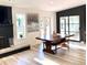 Bright dining room featuring a wooden table, bench seating, and contemporary artwork at 15602 N 37Th St, Phoenix, AZ 85032