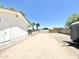 Large, gravel driveway with a white building, possible RV parking and a privacy gate at 15602 N 37Th St, Phoenix, AZ 85032