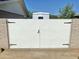 White gate between brick columns with partial view of house and clear blue sky at 15602 N 37Th St, Phoenix, AZ 85032