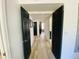Bright hallway with light-colored flooring and contrasting dark paneled doors throughout the home at 15602 N 37Th St, Phoenix, AZ 85032